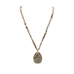 Desert Stone Necklace — Dalmation Beige arranged in a draped flat lay.​