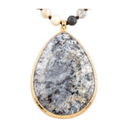 Close-up of the pendant on Desert Stone Necklace — Dalmation Gray.​